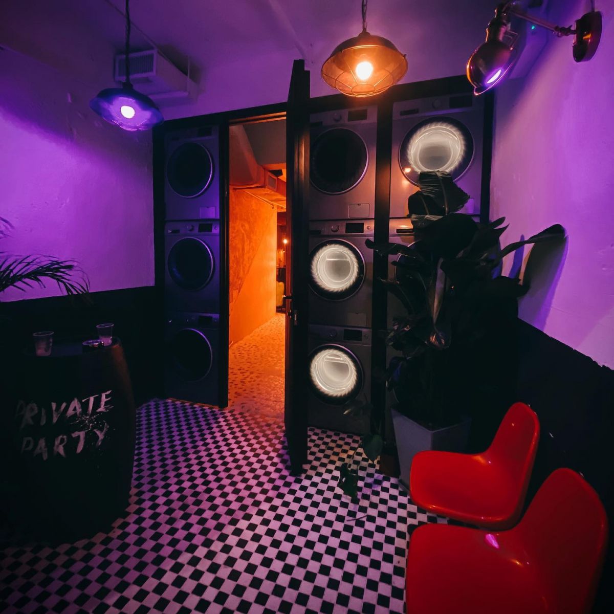 An illuminated laundromat gets "dirty" in the dusk