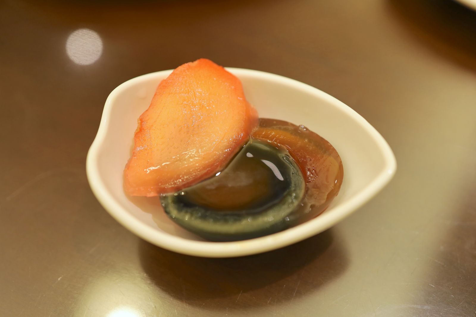 The century egg is served with pickled young ginger.